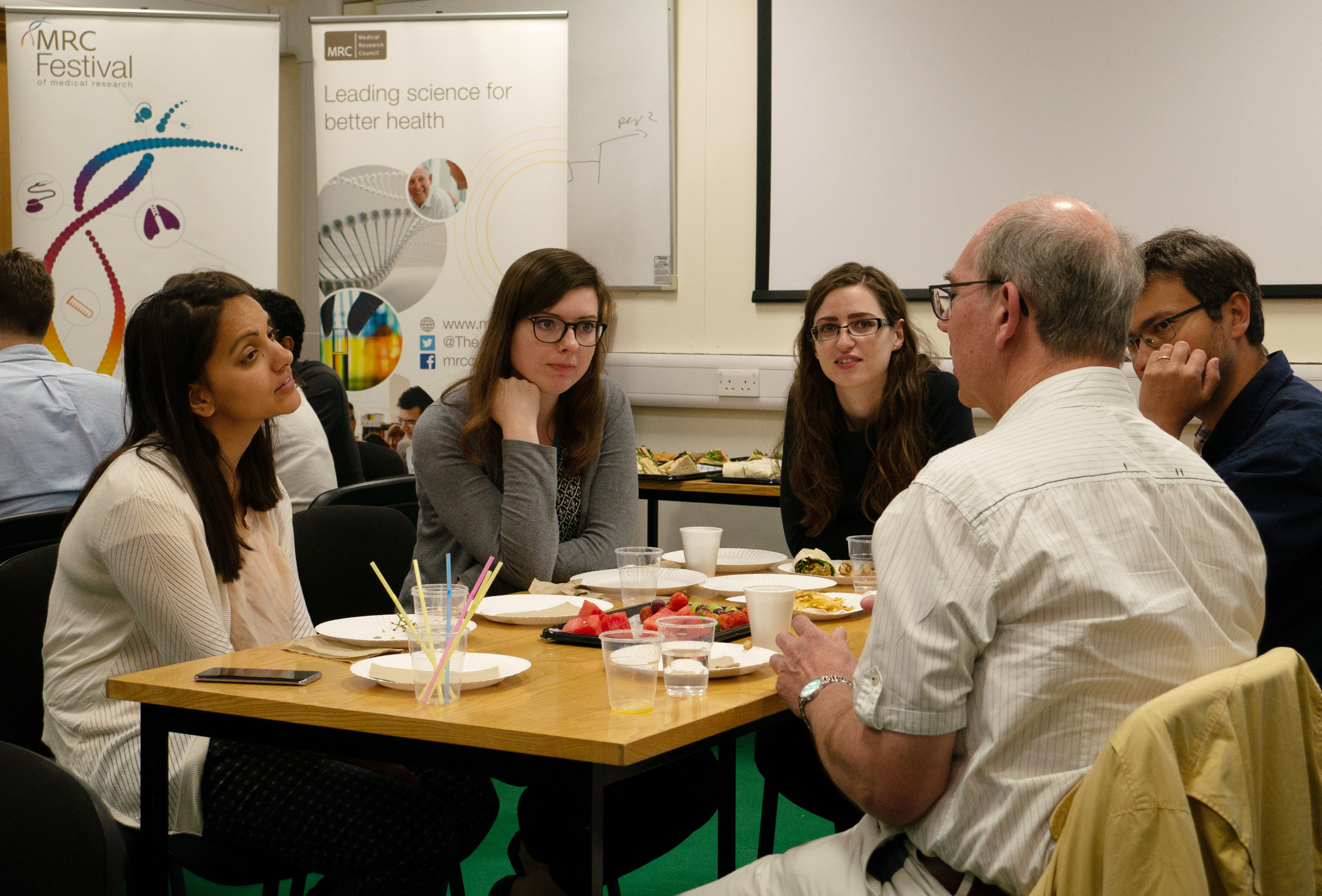 Lay members of Parkinson’s UK chat over lunch with the Unit’s early-career scientists.