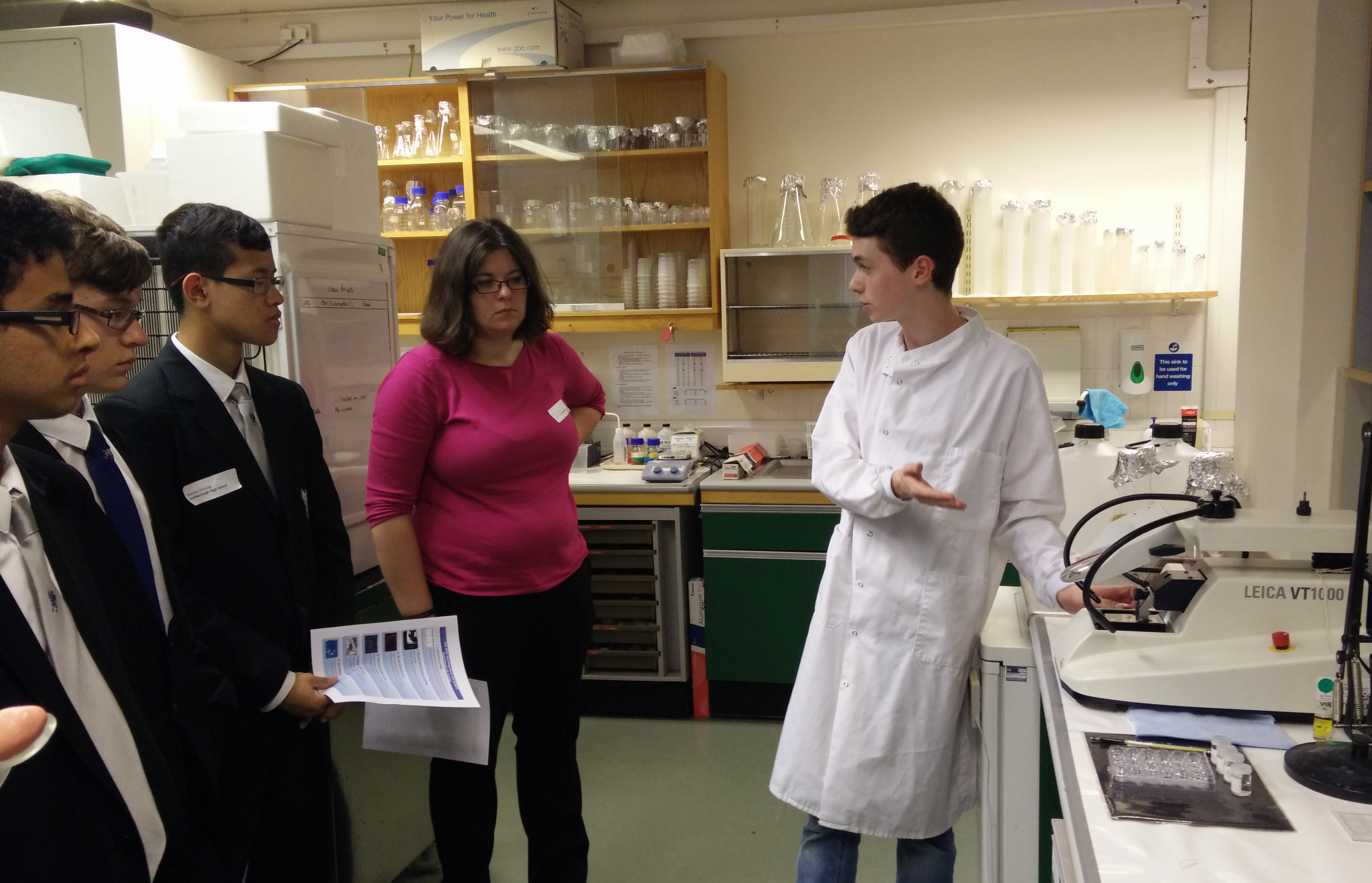 Unit FHS undergraduate student Calum McIntyre shows visiting pupils some of his research on brain structure.