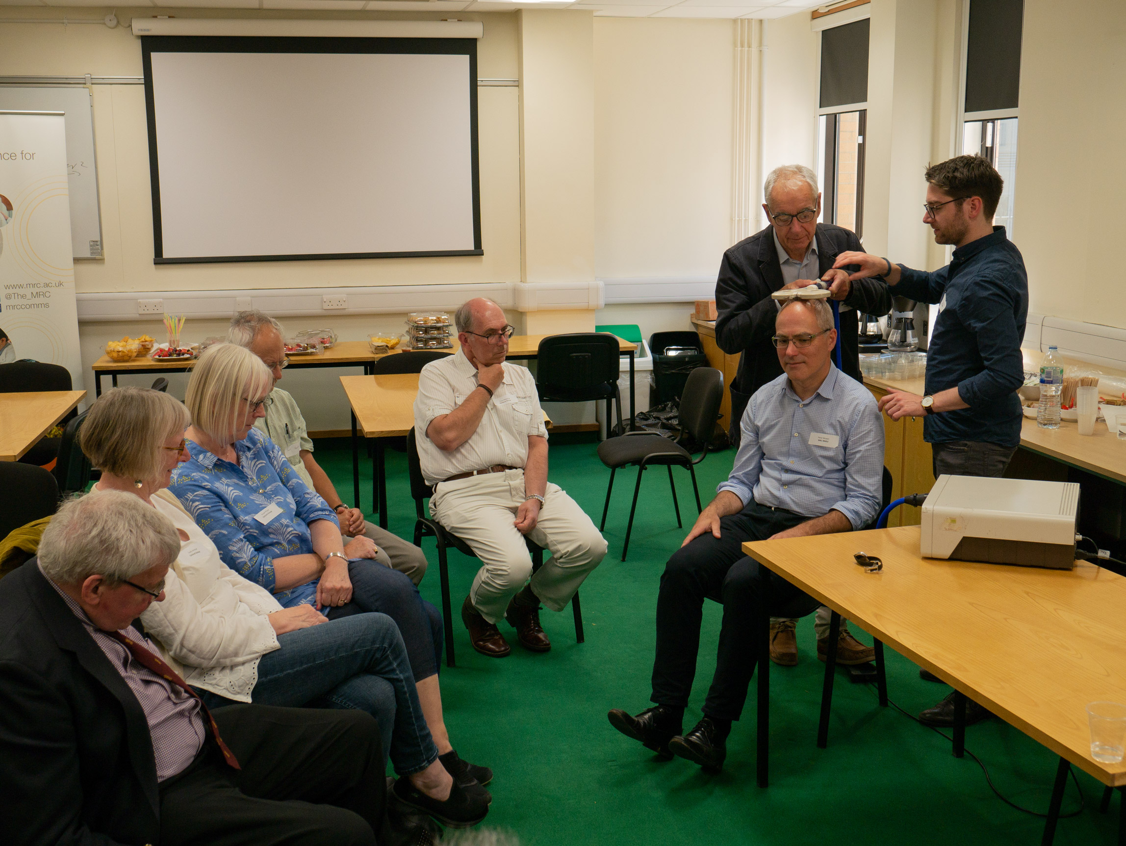 Unit Director Professor Peter Brown volunteers for a live demonstration of Transcranial Magnetic Stimulation of the (his) brain. Sterling example of leadership in to public engagement!