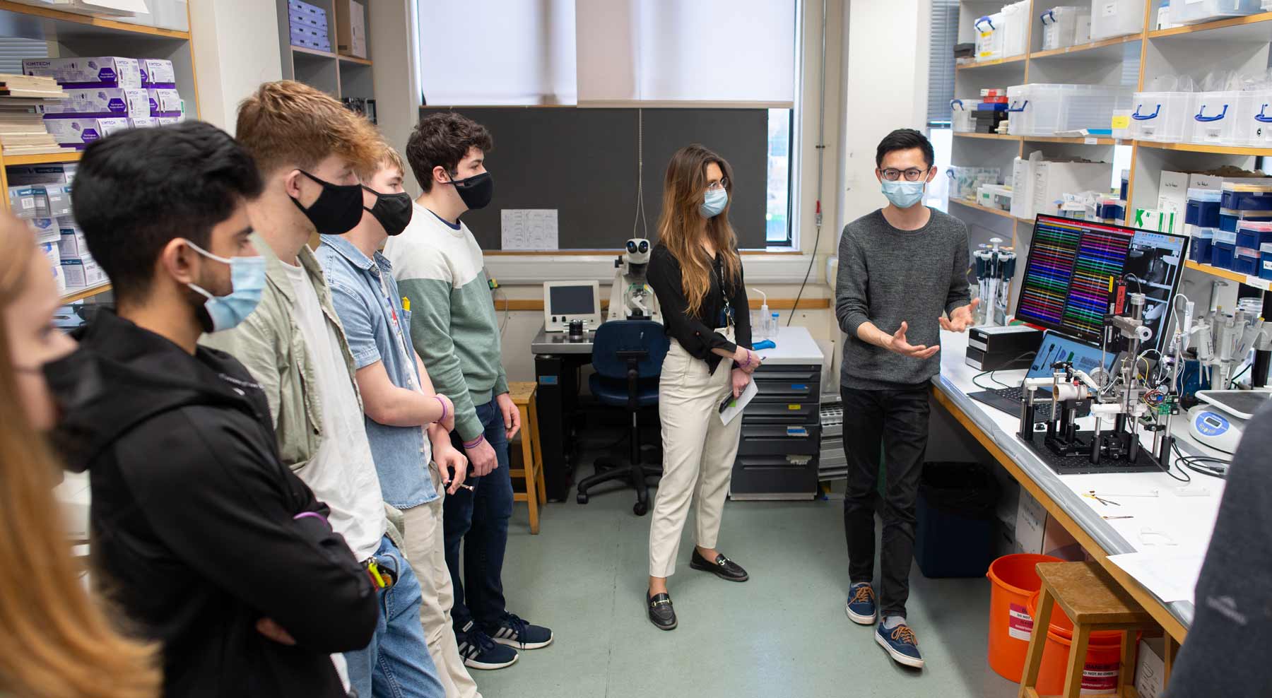 Photo of Yangfan Peng, together with school pupils visiting the MRC BNDU.