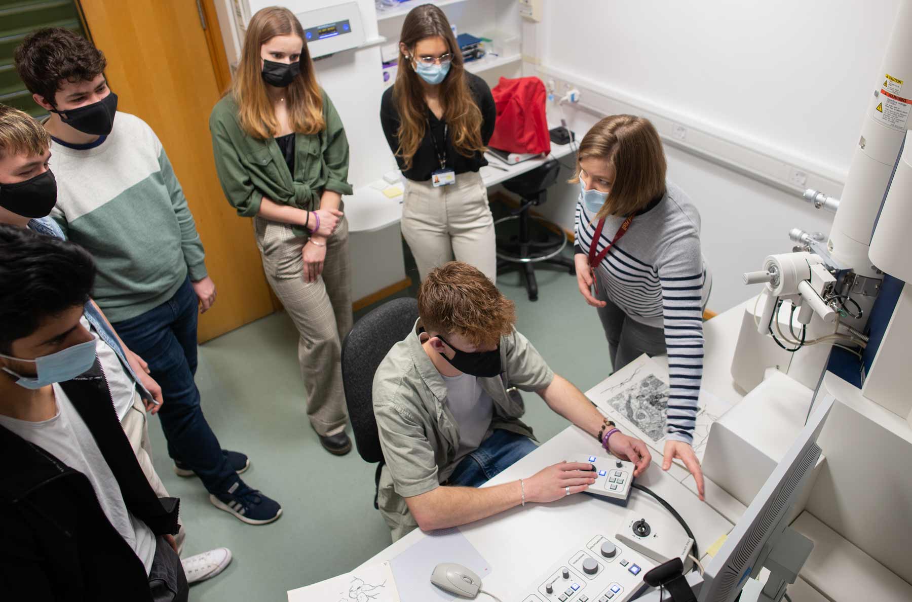 Photo of Natalie Doig, together with school pupils visiting the MRC BNDU.