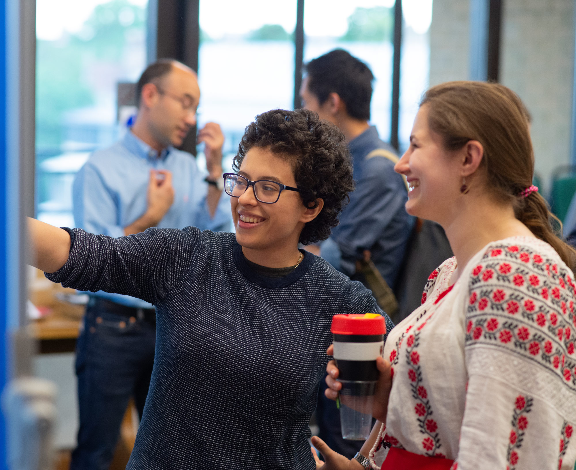 A photo of Cal Shearer and Ioana Grigoras talking at summer Science Day 2022.