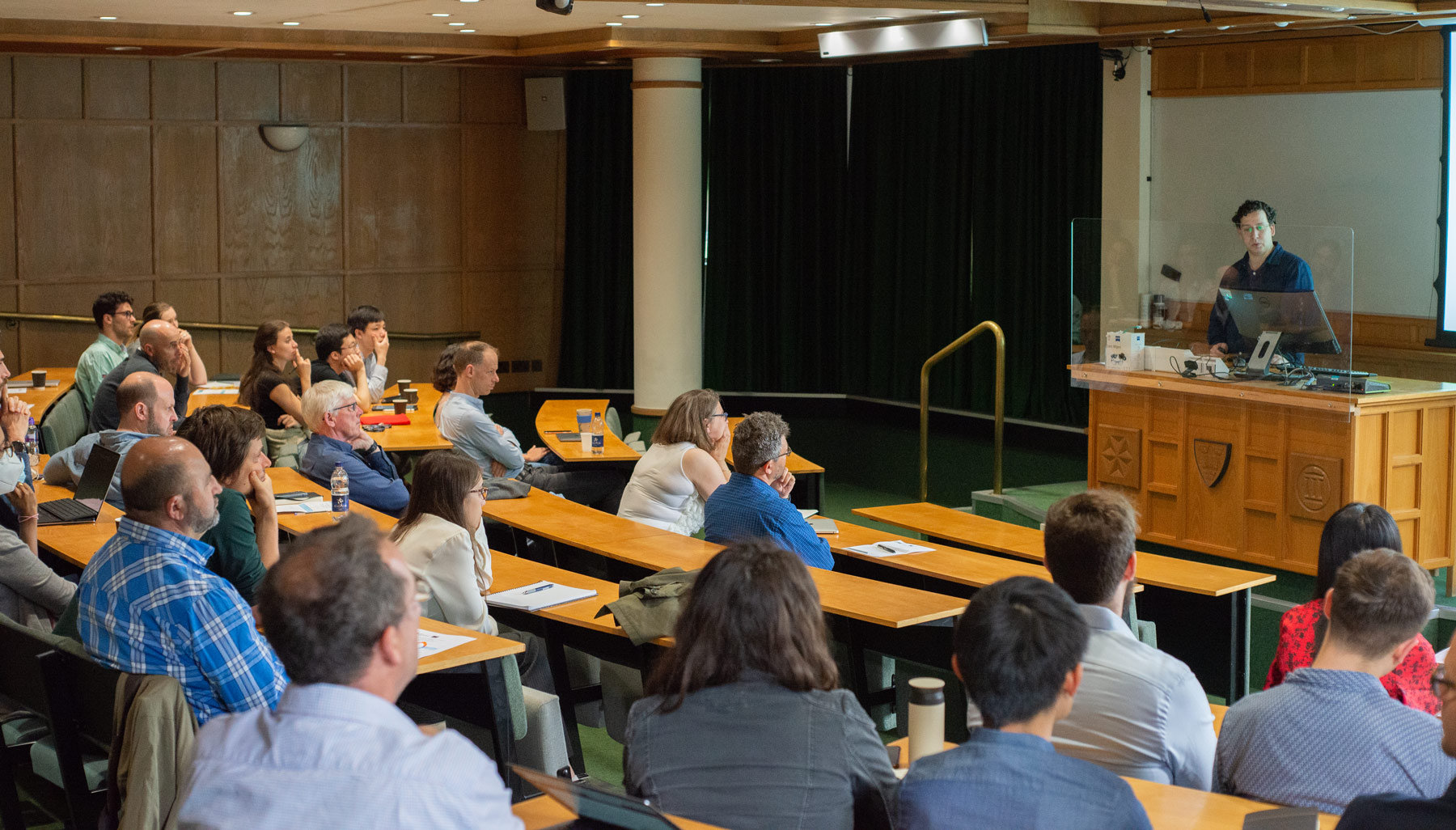 A photo of Guy Yona presenting his research to Unit colleagues.