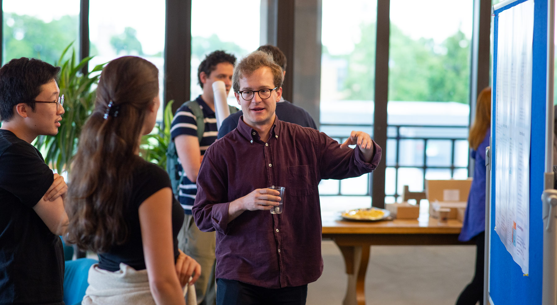 A photo of James Sermon and Unit colleagues talking at summer Science Day 2022.