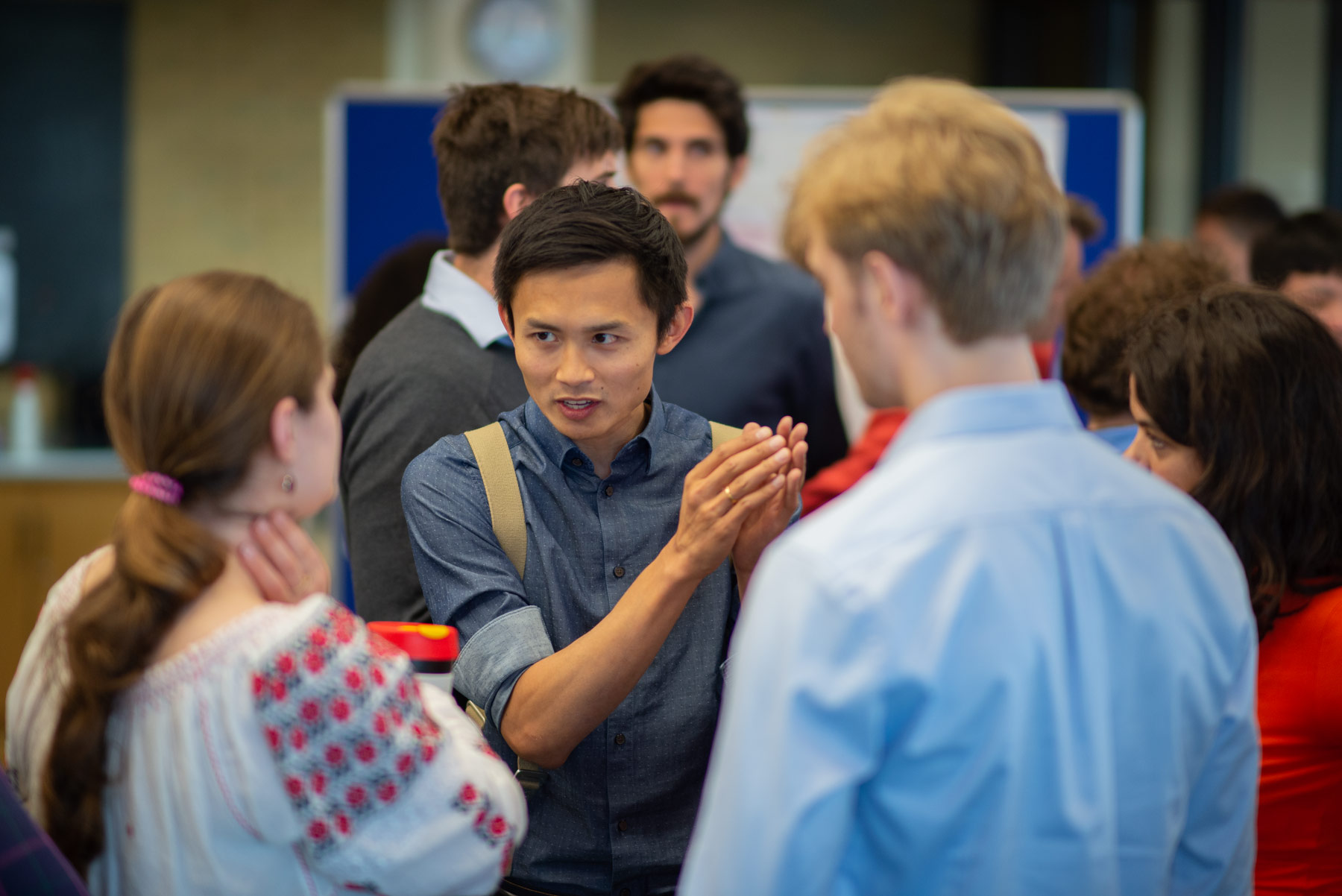 A photo of Yangfan Peng and Unit colleagues talking at summer Science Day 2022.