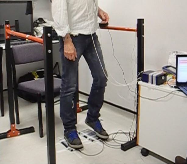 Photo of a volunteer’s legs during a study session, showing the participant stepping on force plates.