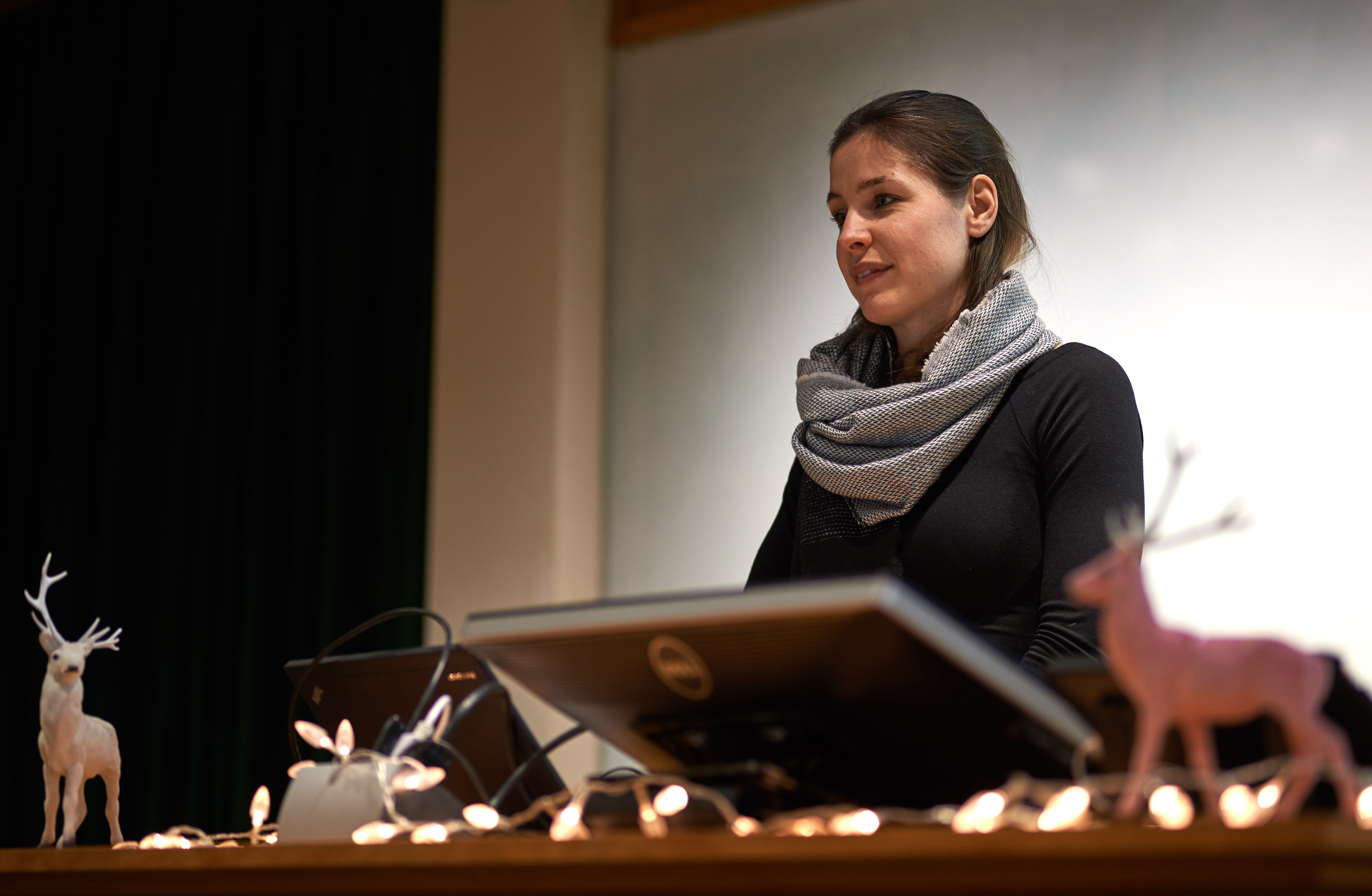 Unit student Anna-Kristen Kaufmann (accompanied by festive friends) takes questions from the audience after her presentation.