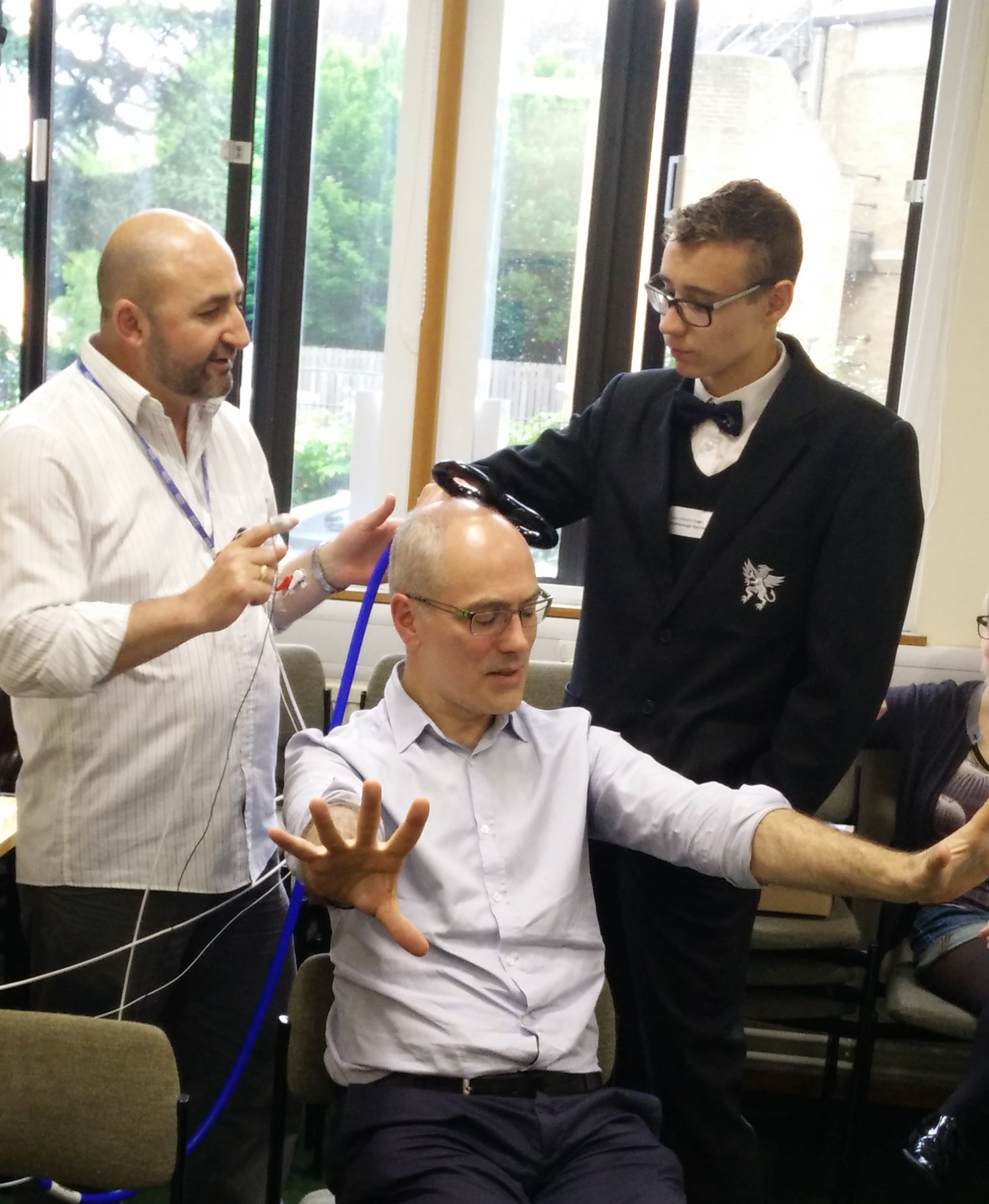 Pupils explore the science of human brain stimulation (as demonstrated on Unit Director Professor Peter Brown!)