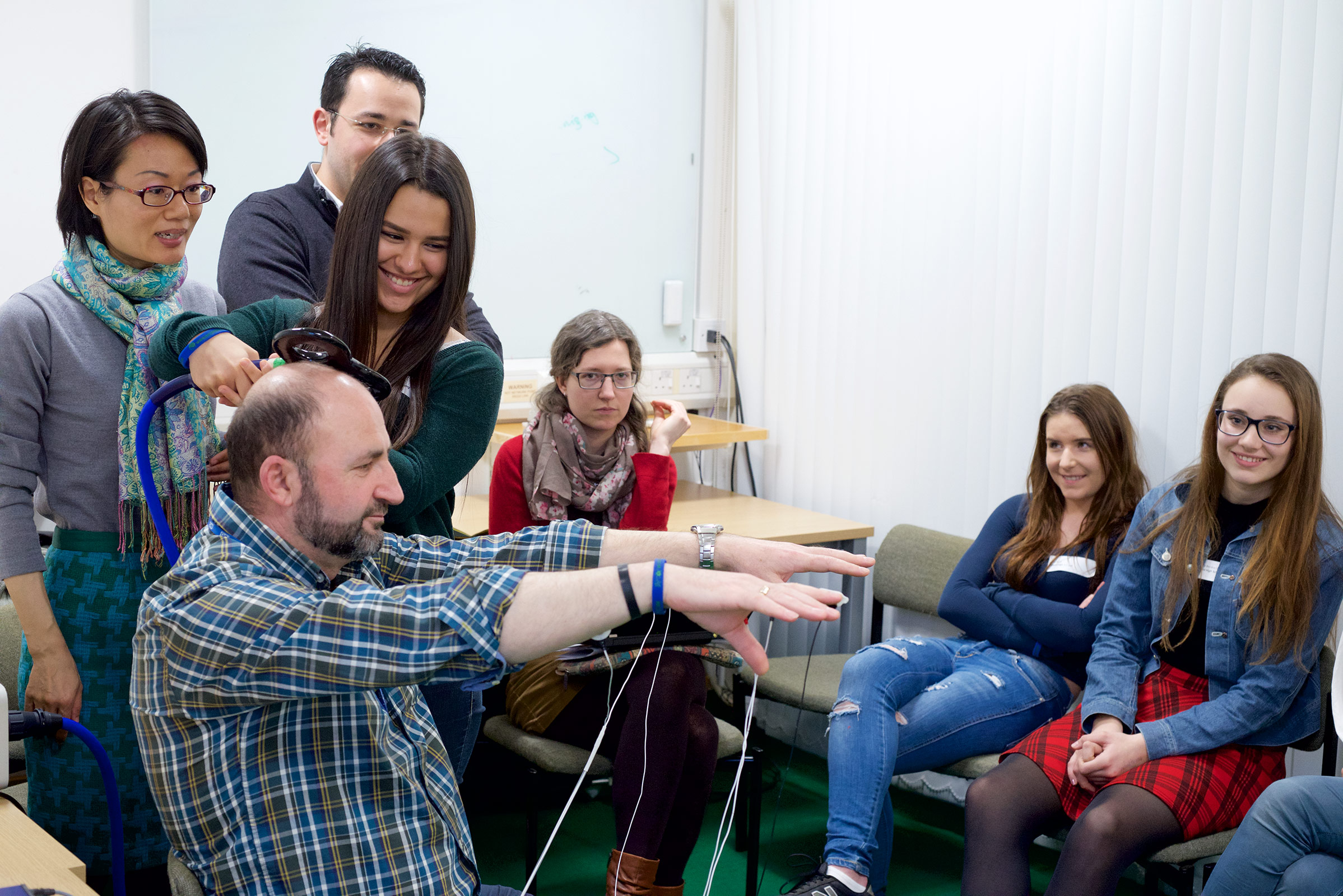 Pupils enthusiastically get to grips with the science of brain stimulation (as demonstrated on everyone’s favourite “volunteer”, Unit scientist Dr Alek Pogosyan!)