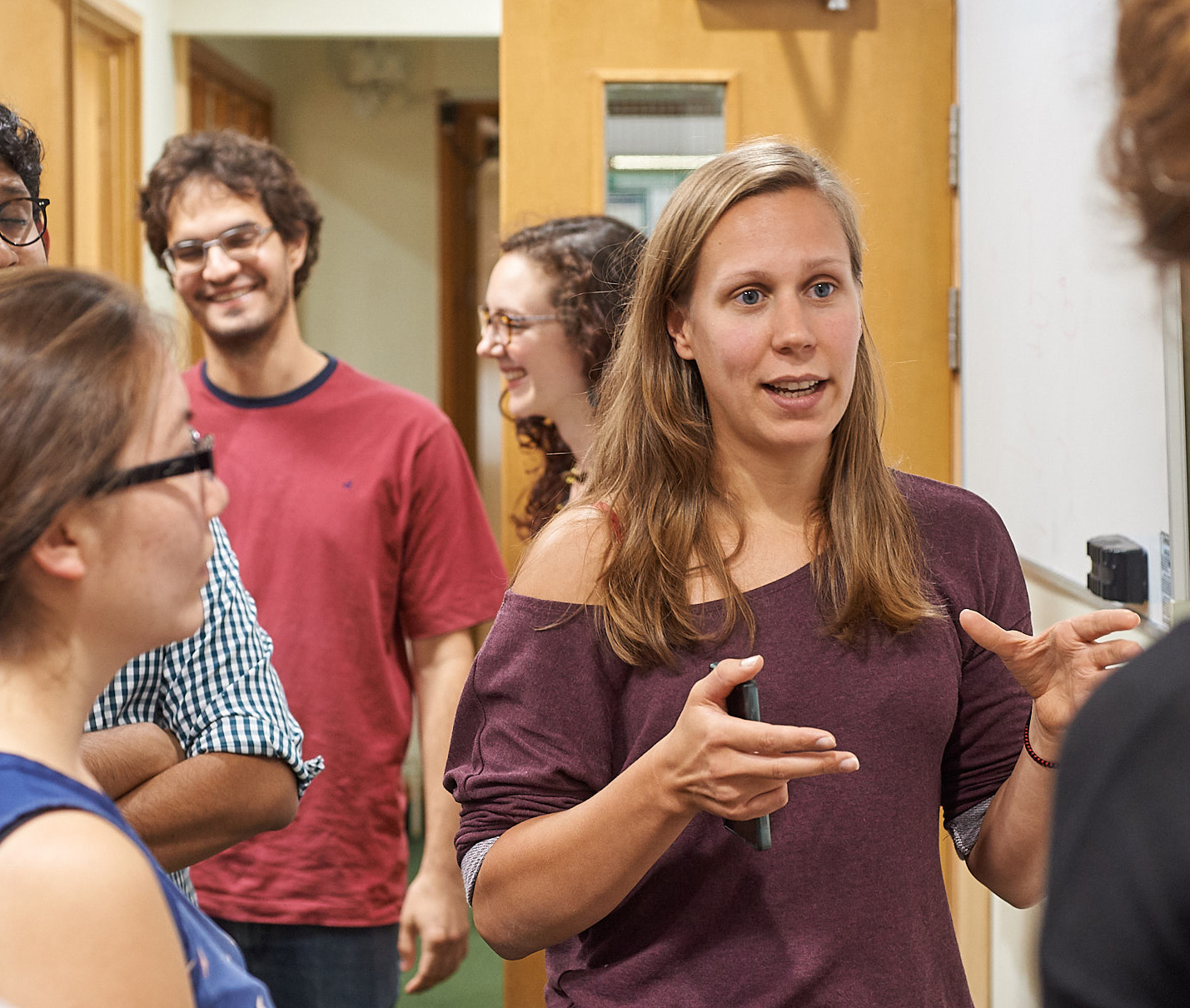 Unit student Maaike van Swieten (centre) explains the latest discoveries shown in her poster at summer Science Day 2017.