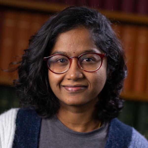 Portrait photo of Alekhya with books in the background