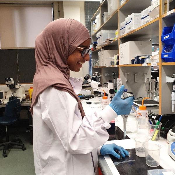 Photo of a visiting In2scienceUK school pupil working at a lab bench