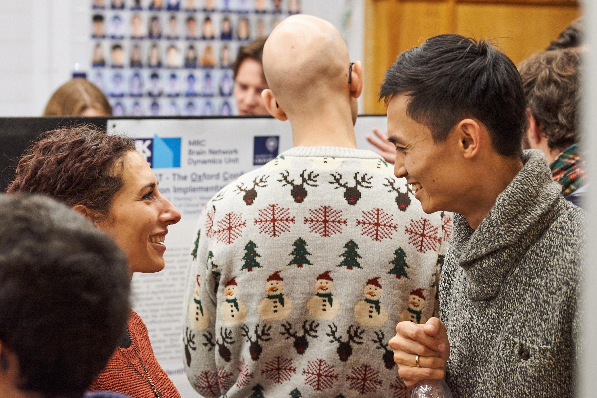 A photo of Melissa Serrano and Yangfan Peng talking at winter Science Day 2022.