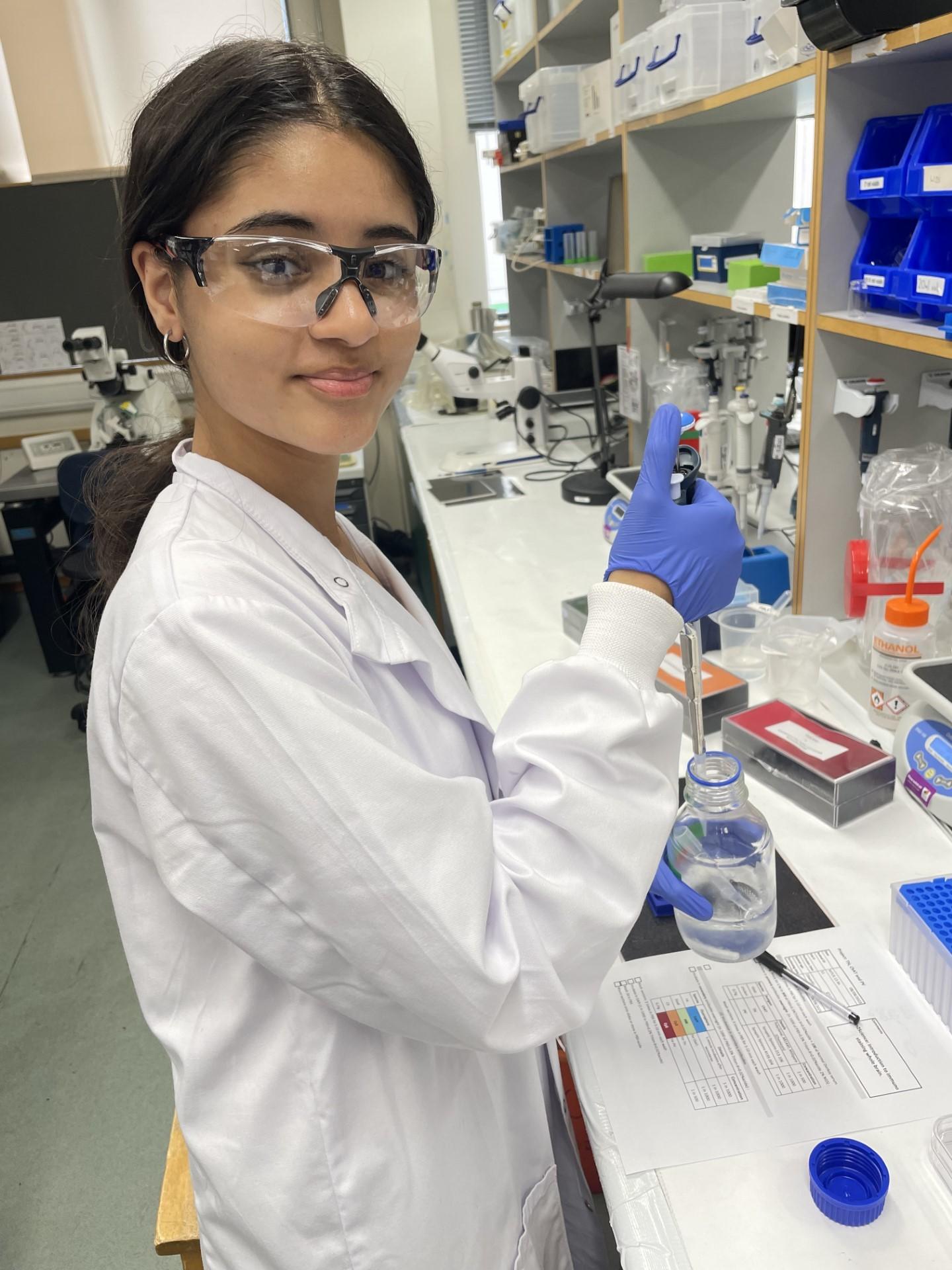 Photo of a visiting In2scienceUK school pupil working at a lab bench.