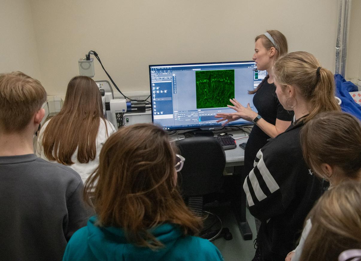 Photo of Demi Brizee speaking with school pupils visiting the Unit.