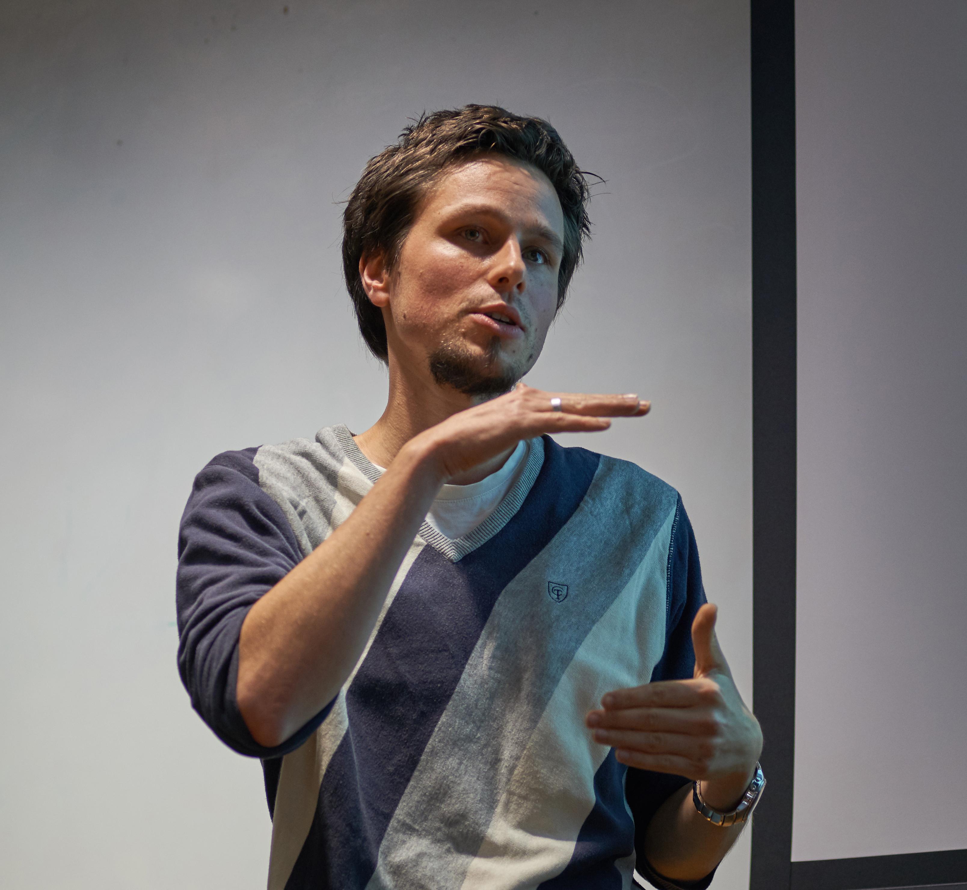 Dr Damian Herz Alt text: A photo of Dr Damian Herz giving a presentation at the MRC Unit