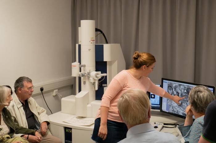Unit postdoctoral scientist Dr Natalie Doig (centre) guides visitors from local Parkinson’s groups as they observe synaptic connections with the Unit’s electron microscope.