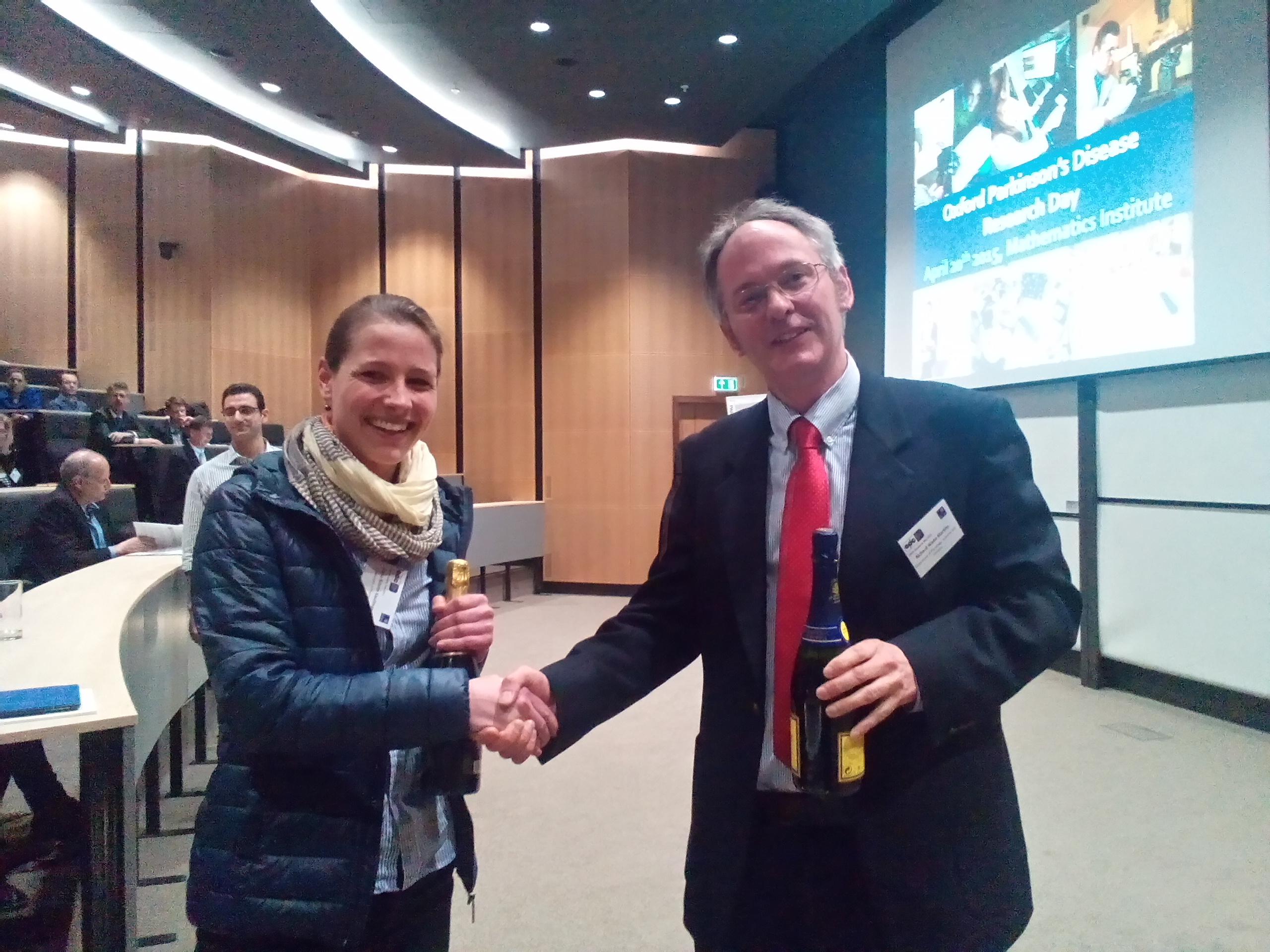Anna-Kristin Kaufmann receives the poster prize from Richard Wade-Martins, who leads the Oxford Parkinson's Disease Centre. 