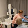 Unit postdoctoral scientist Dr Natalie Doig (centre) guides visitors from local Parkinson’s groups as they observe synaptic connections with the Unit’s electron microscope.