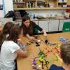 Unit scientist Dr Abbey Holt helps a pupil to remotely control a robotic device by mind and muscle